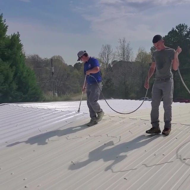 Roofers spray silicone roofing.