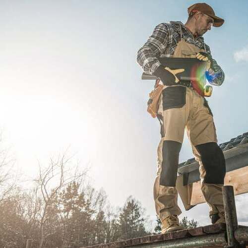 Roofer inspects roof.